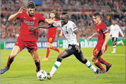  ?? Picture: REUTERS ?? CLOSE ENCOUNTER OF A DIFFERENT KIND: Liverpool’s Sadio Mane, left, and Roma's Federico Fazio fight for the ball during the Champions League semifinal second leg clash at the Stadio Olimpico Stadium in Rome on Wednesday. It was a night when the Reds...