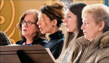  ?? James Franco / Special to the Times Union ?? The choir at the St. Nicholas Ukrainian Orthodox Church in Troy sings a hymn on Saturday during a prayer service for Ukraine and its people.