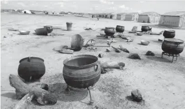  ??  ?? Empty pots in an open kitchen at Bakassi camp where food has not been cooked for IDPs for days Tunji Ominri