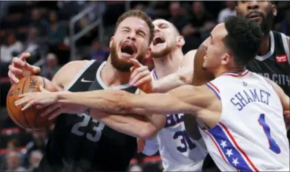  ?? PAUL SANCYA — THE ASSOCIATED PRESS ?? Detroit’s Blake Griffin (23) is fouled by the Sixers’ Mike Muscala (31) as Landry Shamet (1) reaches in Friday.