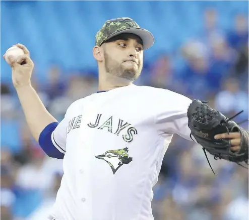  ?? FRED THORNHILL / THE CANADIAN PRESS ?? Toronto Blue Jays starting pitcher Marco Estrada throws against the New York Yankees Monday in Toronto. Estrada gave up only three hits, walked three and struck out six to improve his record to 3-2 with Toronto’s win.