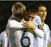  ?? FERNANDO VERGARA / ASSOCIATED PRESS ?? Argentina’s Lionel Messi (center) gets a hug after one of his three goals against Ecuador. Argentina got a win to be assured of advancing.