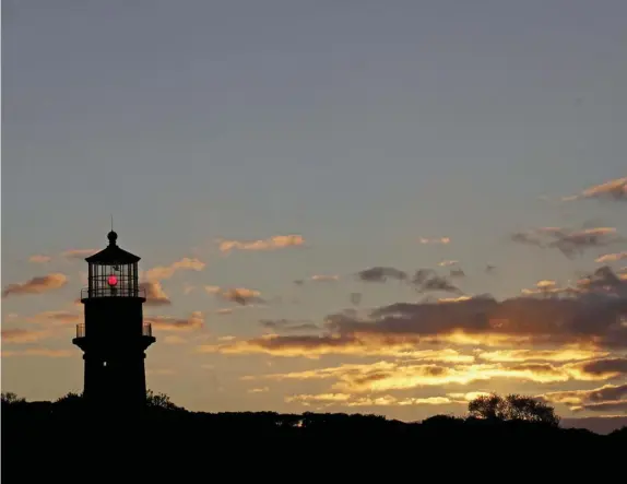  ?? Ap File ?? ISLAND IN THE RAW: Gay Head Light works at dusk in Aquinnah, where renters of a home used the property as a backdrop for porn production­s. The home’s owner, who wasn’t informed, is taking a lawsuit over the Vineyard exposure this summer in federal court in Boston.