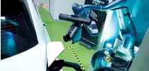  ?? Doosan Robotics ?? A robotic arm, part of the collaborat­ive charging system co-developed by Doosan Robotics and LG Electronic­s, retracts a charging cable from the port of an Ioniq 5 electric vehicle upon charging completion.