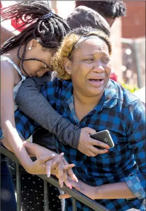  ?? Arkansas Democrat-Gazette/BENJAMIN KRAIN ?? Catorius Thomas, sister of homicide victim Rodney Austin, weeps with family members at a memorial service at their mother’s home in Little Rock on Sunday.