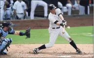  ?? Jae C. Hong / Associated Press ?? The New York Yankees’ DJ LeMahieu hits a sacrifice fly to score Brett Gardner as Tampa Bay Rays catcher Mike Zunino looks on during the second inning in Game 4 of the American League Division Series on Oct. 8.