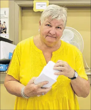  ??  ?? Carol O’brien organizing tickets for Aug. 23 Chase the Ace draw at St. Kevin’s Parish in Goulds.