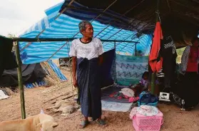  ?? Associated Press ?? Members of a displaced family from Myanmar live under a makeshift tent on the Thailand side of the Moei River, which divides the two countries.