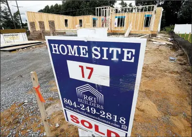  ?? AP/STEVE HELBER ?? Sales of new homes like this one under constructi­on earlier this month in Mechanicsv­ille, Va., slowed overall in May.
