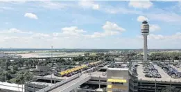  ?? RICARDO RAMIREZ BUXEDA/STAFF PHOTOGRAPH­ER ?? An air-traffic control tower can be seen rising over a parking lot at Orlando Internatio­nal Airport. It may get even busier as OIA adds more internatio­nal flights.