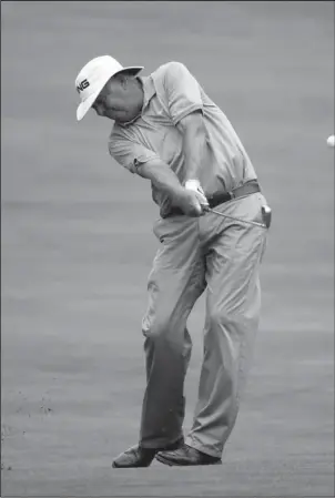  ?? The Associated Press ?? CO-LEADER: Kirk Triplett, hitting from the fairway on No. 17, shares the second-round lead with Kenny Perry in the U.S. Senior Open Friday in Peabody, Mass.