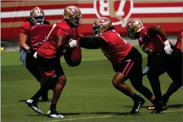  ?? AP PHOTO BY JEFF CHIU ?? San Francisco 49ers’ William Sweet, left, and Trent Williams perform a drill during NFL football practice in Santa Clara, Calif., Wednesday, Sept. 9.