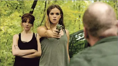  ?? Anchor Bay Films ?? BENT ON REVENGE, Shae (Danielle Panabaker, left) and Lu (Nicole LaLiberte) go on a killing spree in the new “Girls Against Boys.”