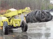  ?? Doug Walker / RN-T ?? A bale of old tires is loaded and on the way into one of the Green Carbon reactors in North Rome for recycling.