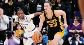  ?? Nam Y. Huh/Associated Press ?? Iowa guard Caitlin Clark (22) drives past Northweste­rn guard Hailey Weaver during the first half in Evanston, Ill., on Wednesday.