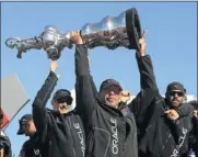  ?? Picture: REUTERS ?? VICTORY: Oracle CEO Larry Ellison lifts the America’s Cup with members of the Oracle Team USA.