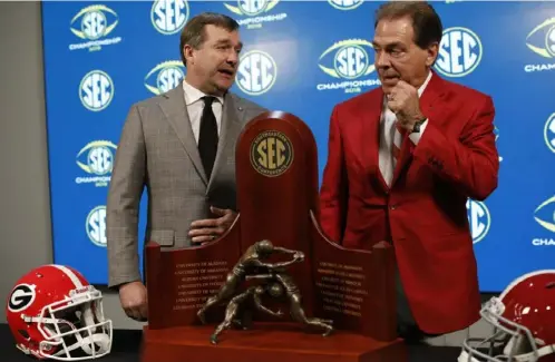  ?? Joshua L. Jones/Associated Press ?? Georgia’s Kirby Smart, left, coached under Alabama’s Nick Saban before leaving to revive the program at his alma mater.