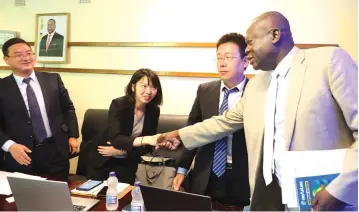  ?? — Picture: Justin Mutenda ?? Lands, Agricultur­e, Water and Rural Resettleme­nt Minister Perrance Shiri welcomes the China Lesso Group delegation headed by Tang Hai Bo (left) in Harare yesterday.