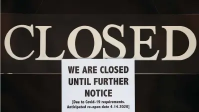  ?? The Associated Press ?? ■ In this April 2, 2020, file photo, a notice of closure is posted at The Great Frame Up in Grosse Pointe Woods, Mich. President Donald Trump rolled out the Paycheck Protection Program to catapult the U.S. economy into a quick recovery from the coronaviru­s pandemic. President Joe Biden tweaked it to try to direct more of the money to poorer communitie­s and minority-owned companies. Now, almost two years after the program made its debut, what did taxpayers get for the $800 billion?