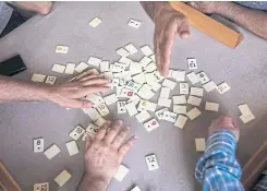  ??  ?? ABOVE
Men play a round of “okey,” a popular game similar to rummy, at a coffeehous­e in Istanbul.