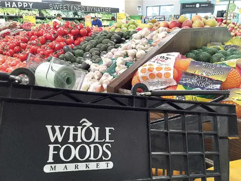  ?? AP Photo/Elise Amendola ?? Produce is displayed June 5 at Whole Foods Market in Andover, Mass. Amazon is buying Whole Foods in a deal valued at about $13.7 billion. The two companies have not yet detailed how their proposed union might change the experience for customers. But...