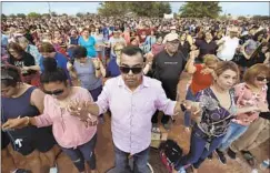  ?? Mark Lambie El Paso Times ?? PEOPLE HOLD hands during a prayer vigil the day after this month’s massacre in El Paso. The suspect told police he was targeting Mexicans.