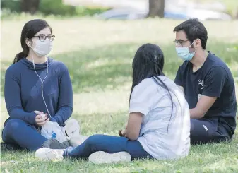  ??  ?? People wear face masks as they gather in a city park on Canada Day in Montreal on July 1. Sexologist Jill McDevitt suggests avoiding online shaming of people who don’t wear masks.