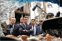  ?? ?? Italian Prime Minister Mario Draghi (left) and French President Emmanuel Macron examine debris June 16 in Irpin, outside Kyiv, Ukraine. The leaders of France, Germany, Italy and Romania arrived in Kyiv, in a
show of collective European support for the Ukrainian people.