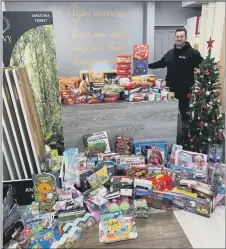  ??  ?? INUNDATED
Dale Herridge with the donated toys and food