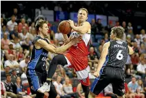  ?? MARK NOLAN/GETTY IMAGES ?? The Hawks’ Tim Coenraad drives to the basket against the Breakers.