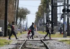  ?? Julio Cortez/Associated Press ?? Migrants walk from an intake tent to a respite center after being released from U.S. Customs and Border Protection custody on Friday in McAllen, Texas.