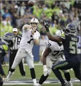  ?? ELAINE THOMPSON — THE ASSOCIATED PRESS ?? Raiders QB Mike Glennon passes against the Seattle Seahawks during Thursday’s final preseason game.