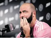  ?? SYDNEY WALSH swalsh@miamiheral­d.com ?? Inter Miami’s Gonzalo Higuaín reacts as he announces his retirement during a press conference on Monday