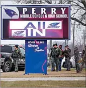  ?? ANDREW HARNIK / AP ?? Police respond to Perry High School Thursday in Perry, Iowa.