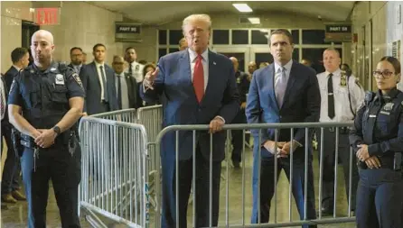  ?? JEFFERSON SIEGEL/THE NEW YORK TIMES ?? Former President Donald Trump and his lawyer, Todd Blanche, talk with the media before a hearing Feb. 15 at the State Supreme Court in Manhattan. Blanche is defending Trump in three of his four criminal cases.