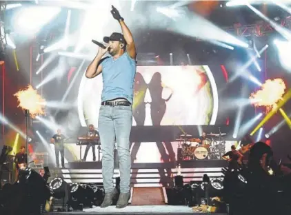  ?? Rick Diamond, Getty Images ?? Luke Bryan performs in Twin Lakes, Wisc., on July 22. He headlines Mile High on Aug. 4.