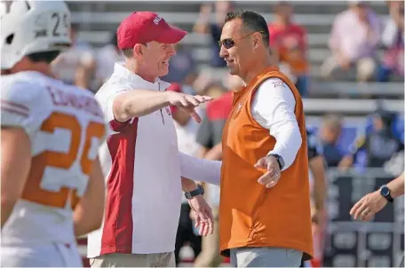  ?? AP PHOTO/LM OTERO ?? Oklahoma football coach Brent Venables, left, and Texas counterpar­t Steve Sarkisian talk before the Big 12 rivals faced off on Oct. 8 in Dallas. Texas was third and Oklahoma fourth Wednesday in 247Sports.com’s composite rankings for the 2023 signing cycle, giving their current conference an overall boost in the recruiting numbers, but both programs are moving in 2025 to the SEC, which had eight of the top 17 signing classes this year.