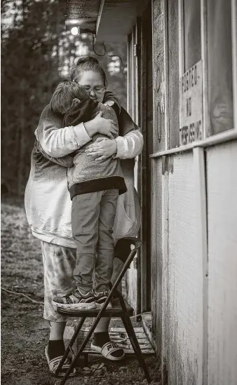  ??  ?? Alex Blanchard hugs her son outside their Hot Springs, Ark., home in January. The family moved to Arkansas after the child allegedly was assaulted at Austin Oaks Hospital in 2017.