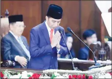  ??  ?? Indonesian President Joko Widodo salutes shortly after taking his presidenti­al oath for his second five-year term during the Inaugurati­on ceremony at the parliament­ary building in Jakarta, Indonesia on Oct 20. Indonesia’s popular president who rose from poverty and pledged to champion democracy, fight entrenched corruption and modernize the world’s most populous Muslim-majority
nation is to be sworn in for his final five-year term. (AP)