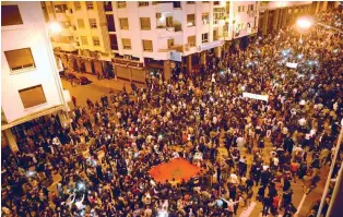  ?? – AFP ?? UP IN ARMS: People of the Moroccan city of Tangier protest against the high price of the electricit­y on Saturday in Tangier.