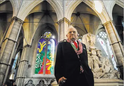  ??  ?? The Associated Press British artist David Hockney stands in front of The Queen’s Window, a new stained glass window at Westminste­r Abbey in London designed by Hockney and revealed for the first time on Wednesday.