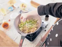  ?? DENNIS WELSH/THE NEW YORK TIMES ?? Watcharee Limanon, a cooking teacher, makes pad Thai in Yarmouth, Maine, on March 15.