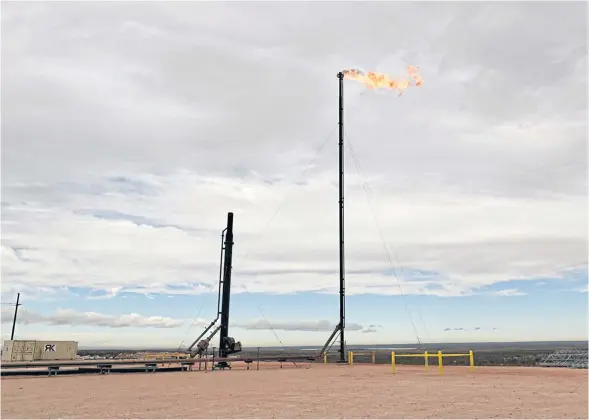  ?? REUTERS ?? Natural gas flares off at a production facility owned by Exxon Mobile Corp near Carlsbad, New Mexico last year.