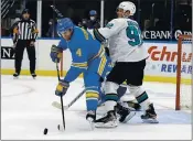  ?? SCOTT KANE — THE ASSOCIATED PRESS ?? The St. Louis Blues’ Carl Gunnarsson (4) handles the puck in front of the San Jose Sharks’ Rudolfs Balcers (92) during the third period Saturday in St. Louis.