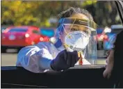  ?? Irfan Khan Los Angeles Times ?? NURSE Marijorie Tabago uses a swab to administer a nasal coronaviru­s test Wednesday in Ontario.