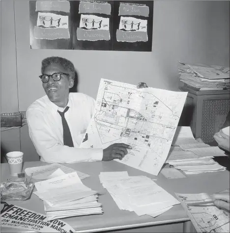  ?? ?? FILE - During a news conference in New York on Aug. 24, 1963, Bayard Rustin, deputy director of the planned March on Washington, points to a map showing the route of the Aug. 28, 1963Civil Rights march. (AP Photo/File)