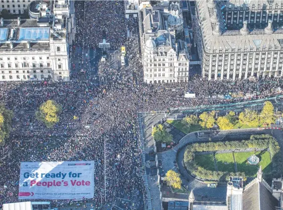  ?? Pictures: AP ?? Anti-Brexit protesters flood London (main, below) while Jacob Rees-Mogg and son Peter (below) are escorted from parliament.