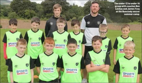  ??  ?? The under-12 to under-14 group with coaches Ben Leckey and James Troy at the Bunclody soccer summer camp.