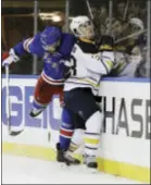  ?? THE ASSOCIATED PRESS ?? Rangers’ Marek Hrivik (46) checks Sabres’ Taylor Fedun (38) during the second period of Tuesday night’s game at Madison Square Garden.