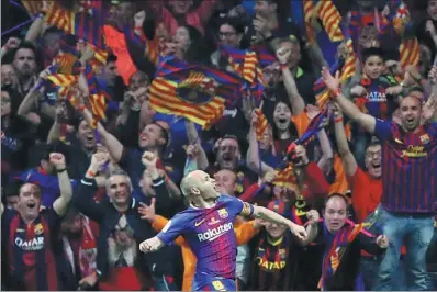 ?? REUTERS ?? Andres Iniesta celebrates scoring Barcelona’s fourth goal in its 5-0 Copa Del Rey victory over Sevilla in Madrid on Saturday. The match looks set to be Iniesta’s last final in a Barca shirt as the Spaniard edges closer to a move to Chongqing Dangdai...